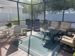 Sunlit open-concept retreat w/granite kitchen island, golf cart & dual lanai.
