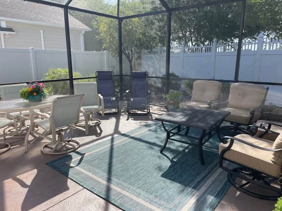 Sunlit open-concept retreat w/granite kitchen island, golf cart & dual lanai.