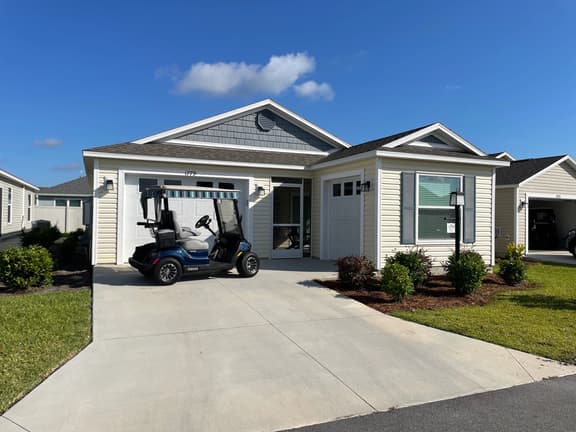 Stylish home with gourmet kitchen, dual garages, and private golf cart!